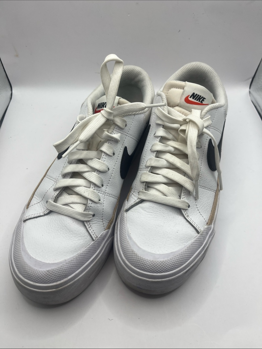 Nike Men’s White Sneakers with Black Swoosh and Orange Tongue Logo